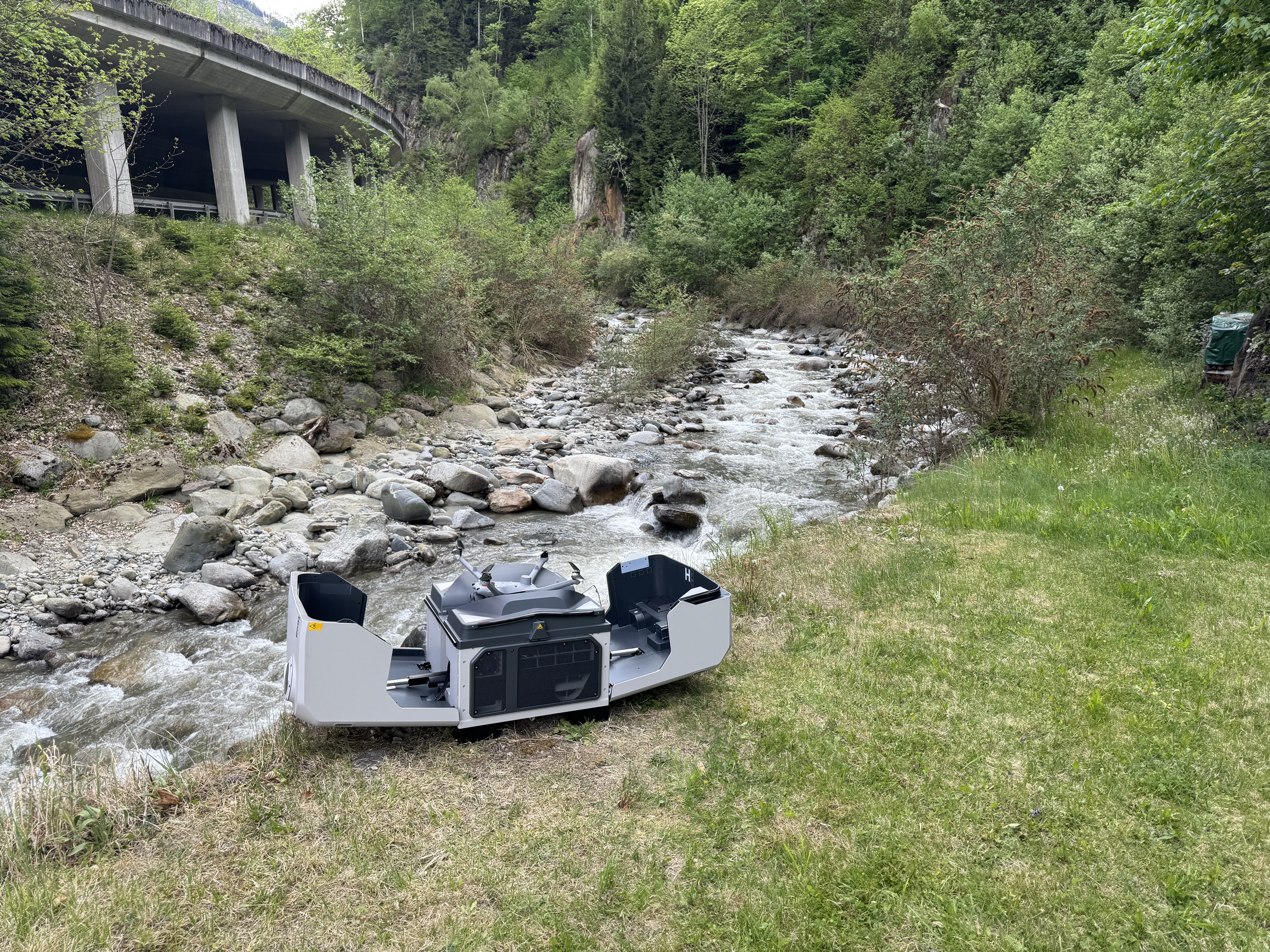 Drone dock in alpine terrain with a drone taking off